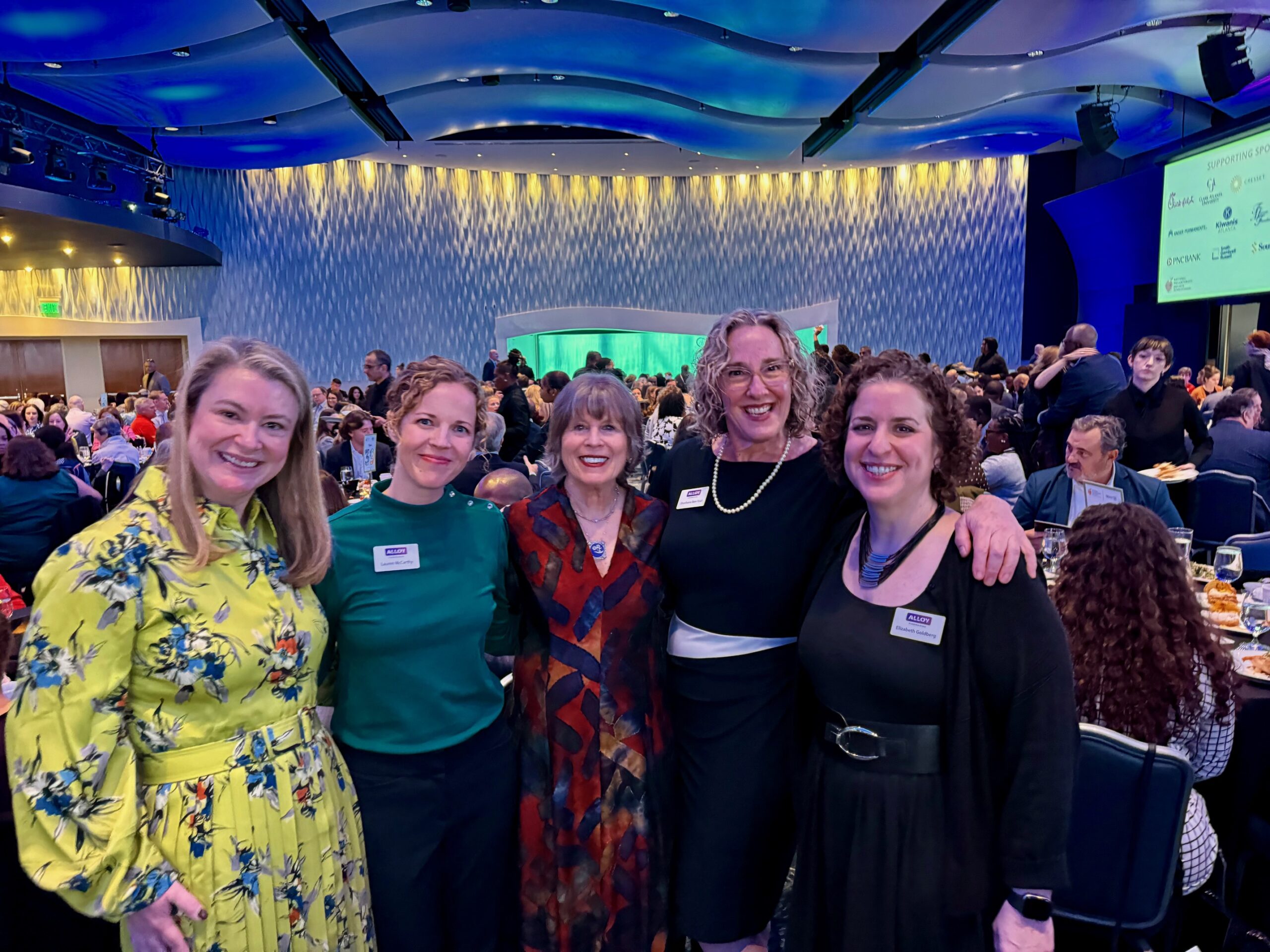 Five women posing at banquet venue