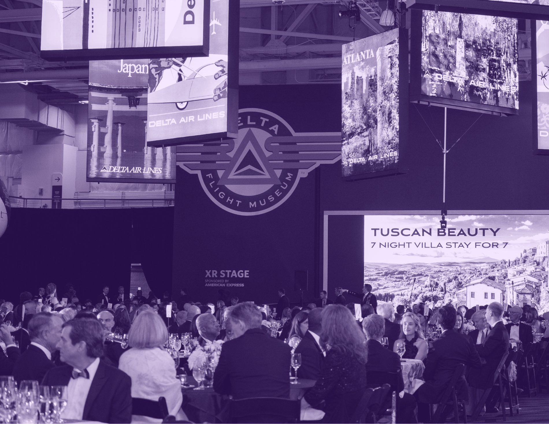 Purple-tinted gala audience at Delta Flight Museum
